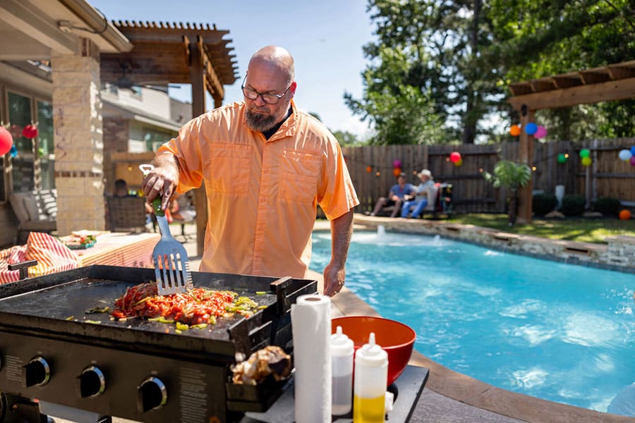 Man Grilling Backyard Party